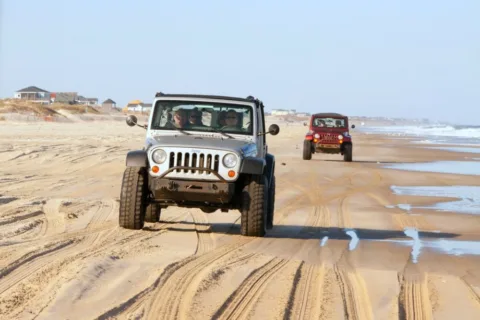 jeeps driving on the beach