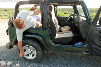 checking-jeep-flat-tire-in-aruba.jpg
