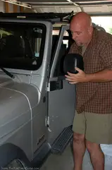 Lifting the Jeep door up and out of the hinges.